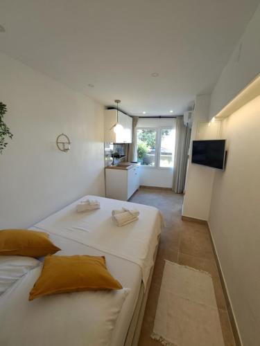 two beds in a small room with a kitchen at Apartment Melany in Senj