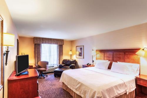 a hotel room with a bed and a television at Hampton Inn Rawlins in Rawlins