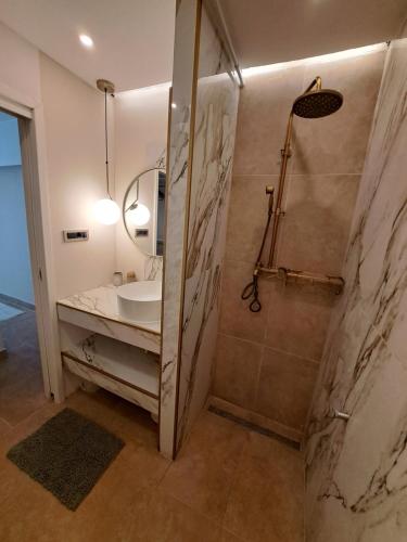 a bathroom with a sink and a shower at Apartment Melany in Senj