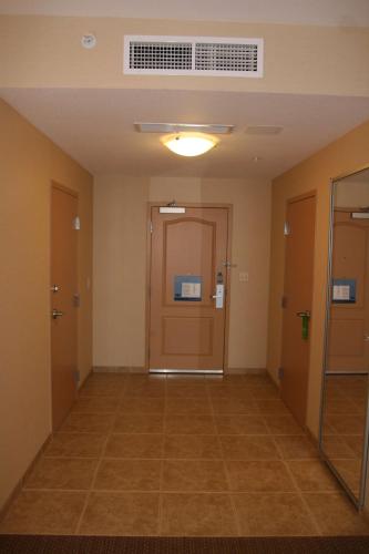 an empty hallway in an office building with a door at Hampton Inn & Suites Folsom in Folsom