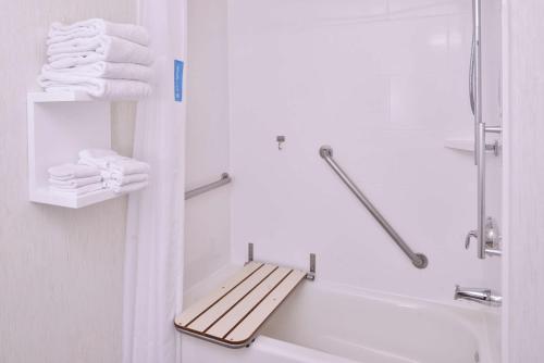 a bathroom with a towel rack next to a bath tub at Hampton Inn & Suites Woodland-Sacramento Area in Woodland