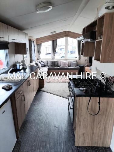 a kitchen and living room of a motorhome at Blue Dolphin Holiday Park in Gristhorpe