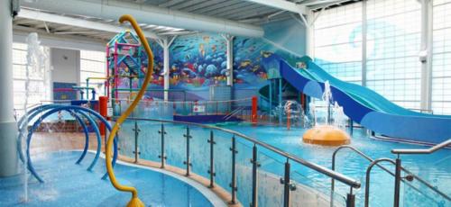a large indoor water park with a water slide at Blue Dolphin Holiday Park in Gristhorpe