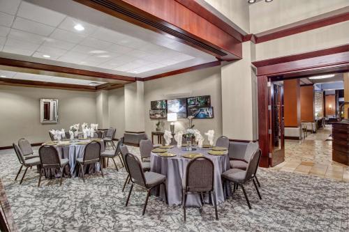 a conference room with tables and chairs and a piano at The Emily Morgan Hotel - A DoubleTree by Hilton in San Antonio