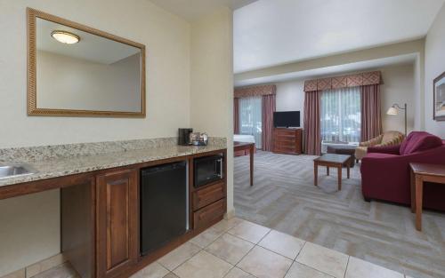 a living room with a large mirror and a living room at Hampton Inn & Suites Lodi in Lodi