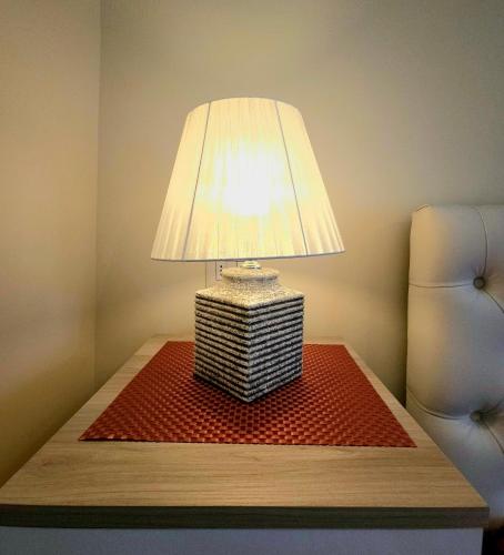 a table with a lamp on top of a table at B&B Donna Francè Pompei - Scafati in Scafati