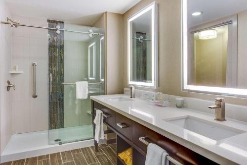 a bathroom with two sinks and a shower at Homewood Suites Savannah Historic District/Riverfront in Savannah