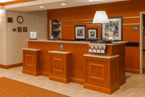a lobby of a hotel with a reception counter at Hampton Inn Goshen in Goshen