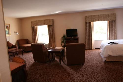 a hotel room with a bed and a television at Hampton Inn Goshen in Goshen