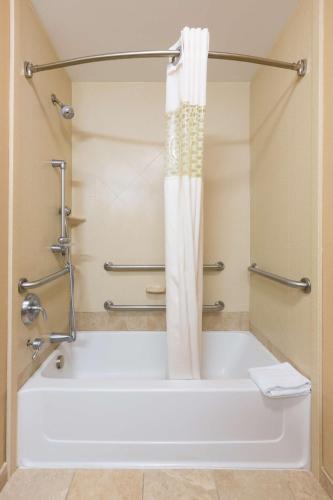 a bath tub with a shower curtain in a bathroom at Hampton Inn Goshen in Goshen