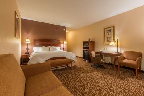 a hotel room with a bed and a desk at Hampton Inn Goshen in Goshen