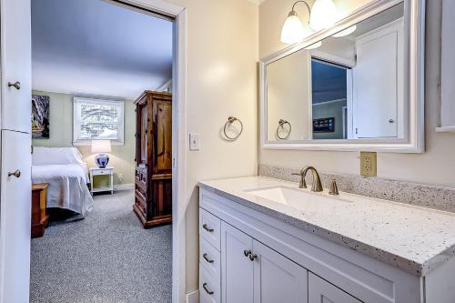 a bathroom with a sink and a bedroom with a bed at Live Like a Local in Charleston