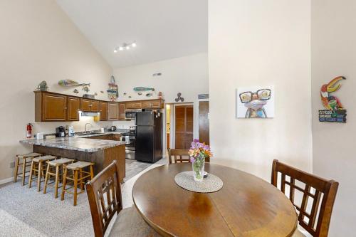a kitchen and dining room with a wooden table and chairs at Golf Colony at Deerfield 26H in Myrtle Beach