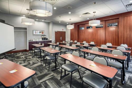 a classroom with tables and chairs and a chalkboard at Hampton Inn Louisville Northeast in Louisville