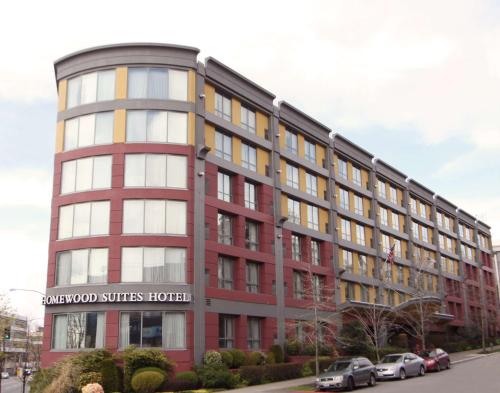 a red building with a sign on the front of it at Homewood Suites by Hilton Seattle Downtown in Seattle