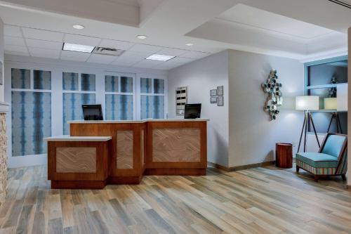 an office with a reception desk and a blue chair at Homewood Suites by Hilton Seattle Downtown in Seattle