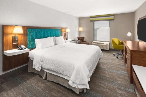 a hotel room with a large bed and a television at Hampton Inn Seekonk in Seekonk