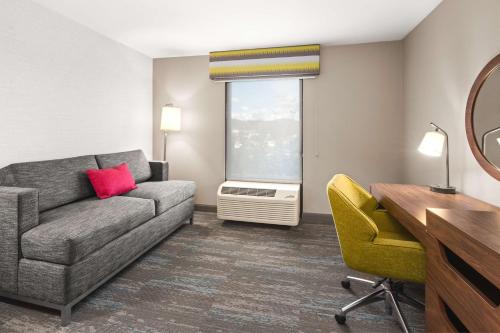a living room with a couch and a desk at Hampton Inn Seekonk in Seekonk