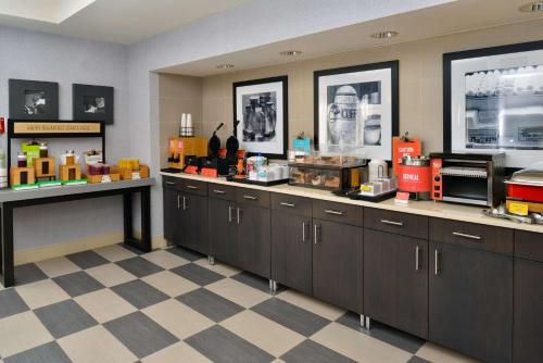 a restaurant kitchen with a counter and a checkered floor at Hampton Inn San Francisco - Daly City in Daly City