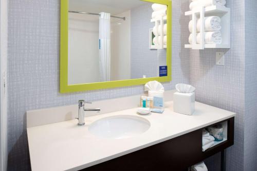 a bathroom with a sink and a mirror at Hampton Inn San Francisco - Daly City in Daly City