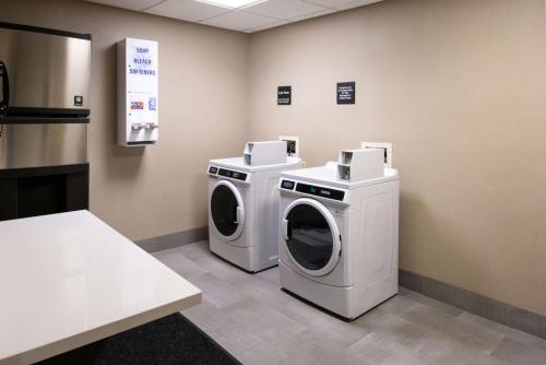 a laundry room with two washing machines and a counter at Hampton Inn San Francisco - Daly City in Daly City