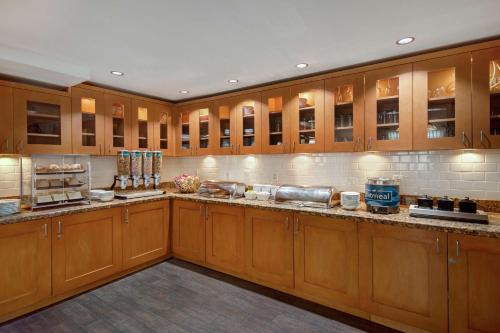 a large kitchen with wooden cabinets and counters at Homewood Suites by Hilton San Francisco Airport North California in Brisbane