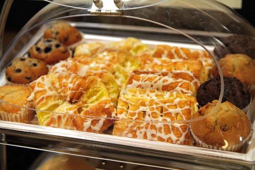 a display case with a bunch of pastries at Hampton Inn Milpitas in Milpitas