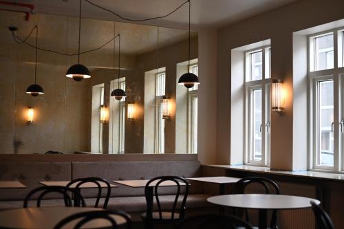 a restaurant with tables and chairs and a large mirror at Hotel Local 101 in Reykjavík