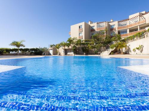 a large swimming pool in front of a building at Live Vista Roja la Tejita in Granadilla de Abona