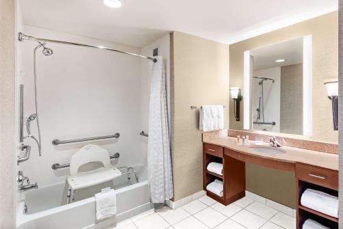 a bathroom with a tub and a toilet and a sink at Homewood Suites by Hilton Shreveport in Shreveport