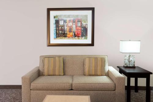 a living room with a couch and a picture on the wall at Homewood Suites by Hilton Shreveport in Shreveport