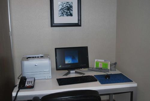 a desk with a computer monitor and a keyboard and mouse at Hampton Inn Shreveport-Airport in Shreveport