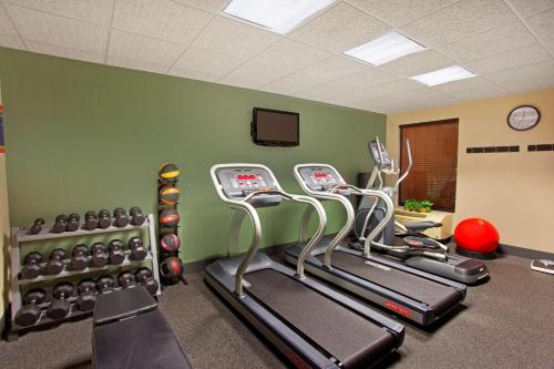 a gym with several cardio machines in a room at Hampton Inn Sidney in Sidney