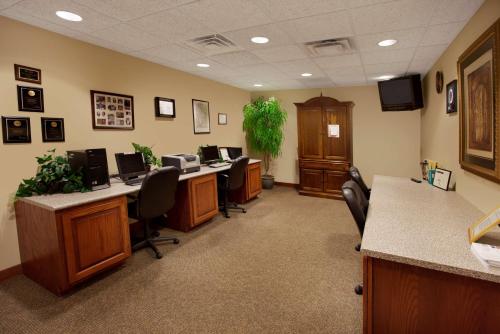 an office cubicle with desks with computers and chairs at Hampton Inn Sidney in Sidney