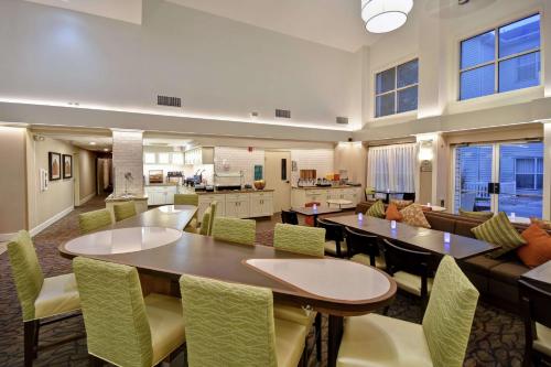 a large living room with a table and chairs at Homewood Suites by Hilton Salt Lake City - Midvale/Sandy in Midvale