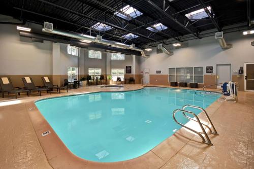 a large swimming pool with chairs around it at Homewood Suites by Hilton Salt Lake City - Midvale/Sandy in Midvale
