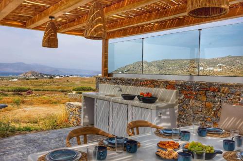 a table with food on it with a view at The Nine Graces - Kastraki Villas with Private Swimming Pool in Kastraki Naxou