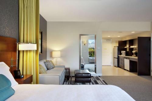 a hotel room with a bed and a couch at Home2 Suites by Hilton West Valley City in West Valley City