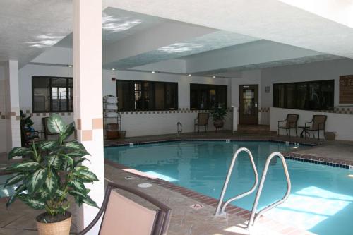 a large swimming pool in a building with chairs around it at Hampton Inn Salt Lake City-Layton in Layton