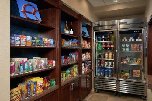 a refrigerator and shelves with food and drinks at Hampton Inn and Suites Salem in Salem