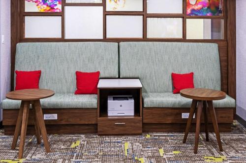 a couch with two tables and red pillows at Hampton Inn Sulphur Lake Charles in Sulphur