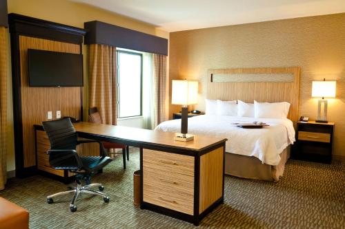 a hotel room with a bed and a desk with a desk at Hampton Inn & Suites Salinas in Salinas