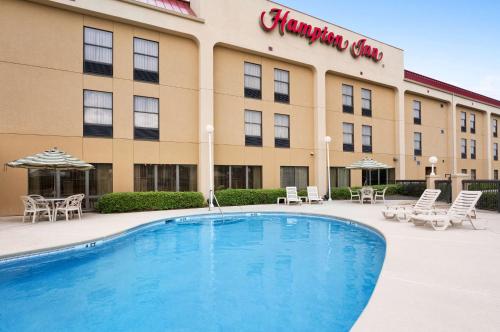 a hotel with a swimming pool in front of a building at Hampton Inn Santee-I-95 in Santee