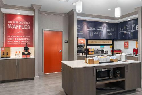 a kitchen with a counter and a red door at Hampton Inn - Springfield in Springfield
