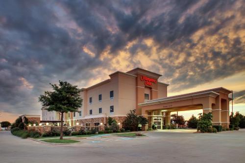 a hotel with a sign on the front of it at Hampton Inn Vernon in Vernon