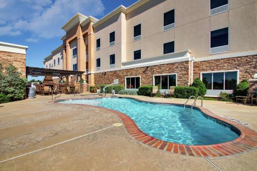 a swimming pool in front of a building at Hampton Inn Vernon in Vernon
