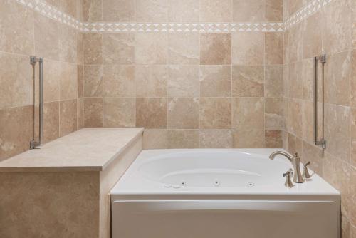 a bathroom with a bath tub and a sink at Hampton Inn Ellenton/Bradenton in Ellenton