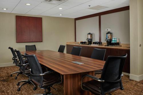 a conference room with a wooden table and chairs at Homewood Suites by Hilton Sarasota in Sarasota