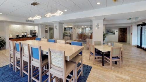 a dining room with a large table and chairs at Hampton Inn St. Simons Island in Saint Simons Island