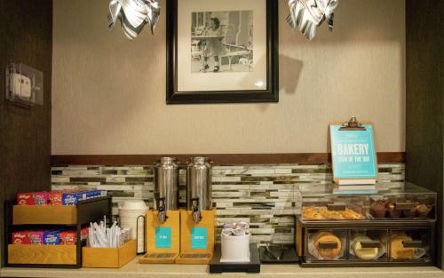 a bakery counter with pastries and other items at Hampton Inn St. Louis-Chesterfield in Chesterfield